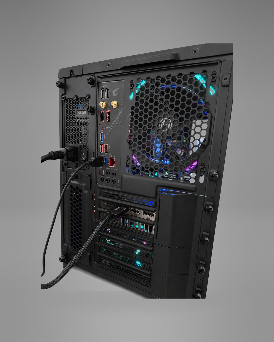 Rear angle of Blackprism 004 showing the motherboard ports, graphics-card outputs and cabling.
